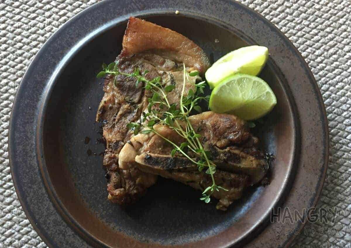 Juicy Tender Pork chops seared and baked in oven with Lemons and Thyme